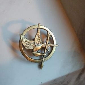 Gold Mockingjay pin.